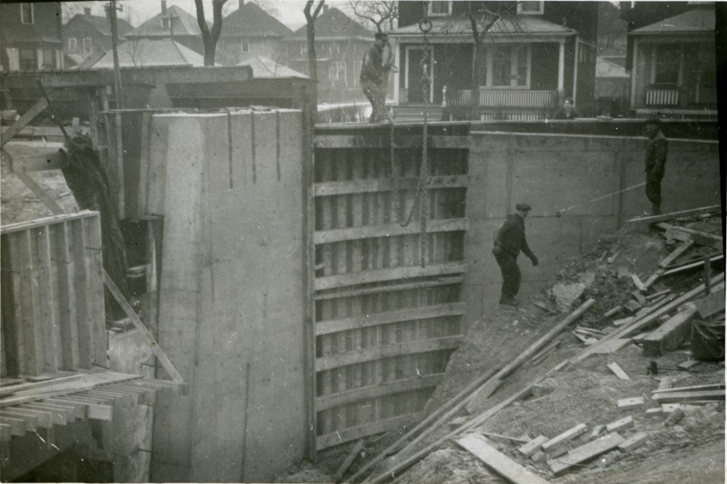 Removing concrete forms on bridge wing wall at Brush Street.